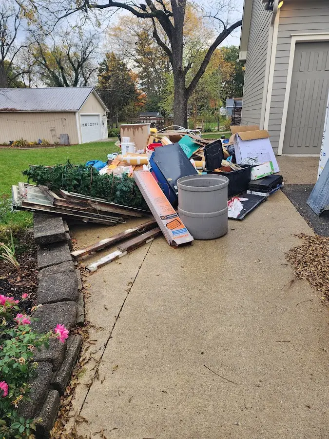 Dumpster being loaded with debris for 10 Yard Dumpster Rental in Sturbridge
